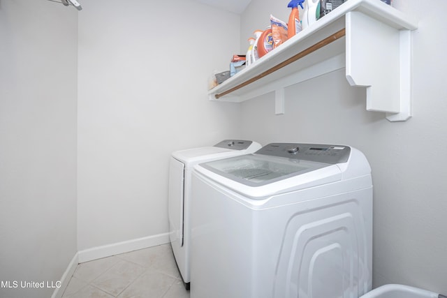 clothes washing area with light tile patterned floors and independent washer and dryer