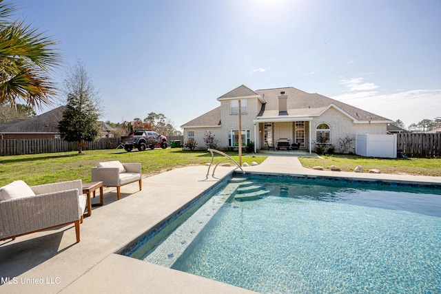 view of swimming pool with a patio, outdoor lounge area, and a lawn