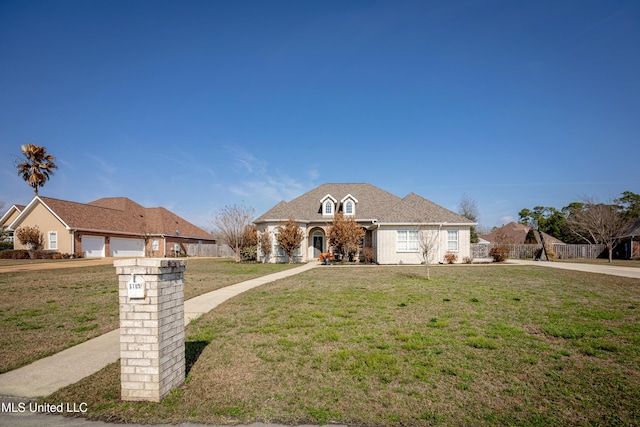 view of front of home with a garage and a front lawn