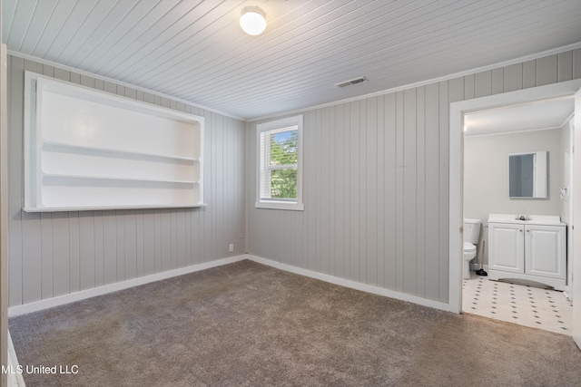 777 W Main St, Senatobia, MS 38668 - carpeted spare room featuring built in shelves, wood walls, ornamental molding, and wooden ceiling