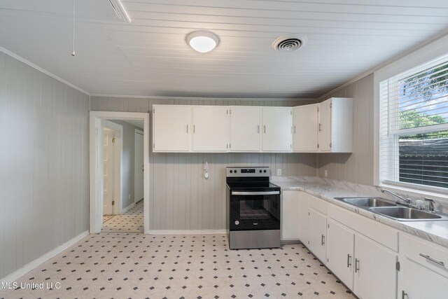 777 W Main St, Senatobia, MS 38668 - kitchen with stainless steel range with electric stovetop, light countertops, light floors, crown molding, and white cabinets