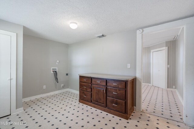 777 W Main St, Senatobia, MS 38668 - laundry area featuring hookup for a washing machine, hookup for an electric dryer, light flooring, and a textured ceiling