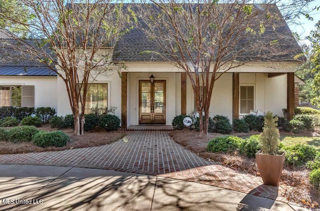 view of exterior entry featuring french doors