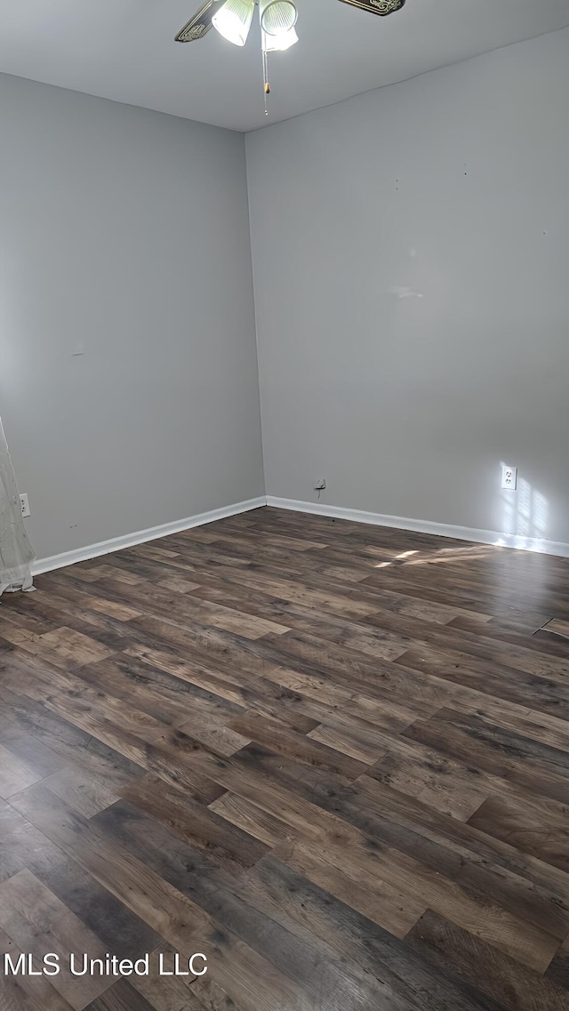 empty room with ceiling fan and dark hardwood / wood-style floors