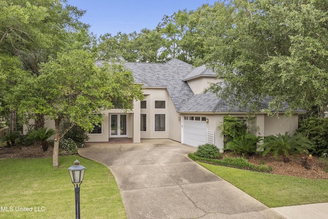 7395 Live Oak Way, Pass Christian, MS 39571 - view of front of property with french doors, stucco siding, a garage, a shingled roof, and a front lawn
