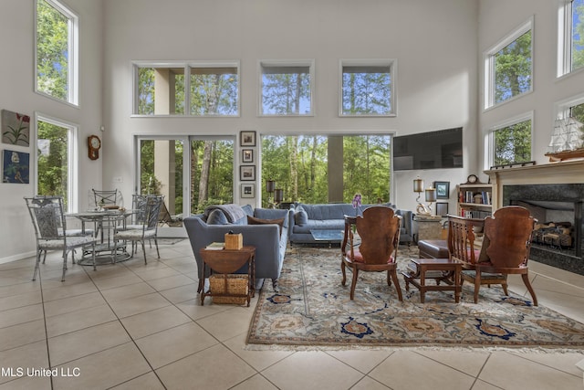 7395 Live Oak Way, Pass Christian, MS 39571 - tiled living room featuring a towering ceiling, healthy amount of natural light, and a fireplace