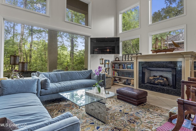 7395 Live Oak Way, Pass Christian, MS 39571 - living room with tile patterned floors, healthy amount of natural light, a premium fireplace, and a towering ceiling