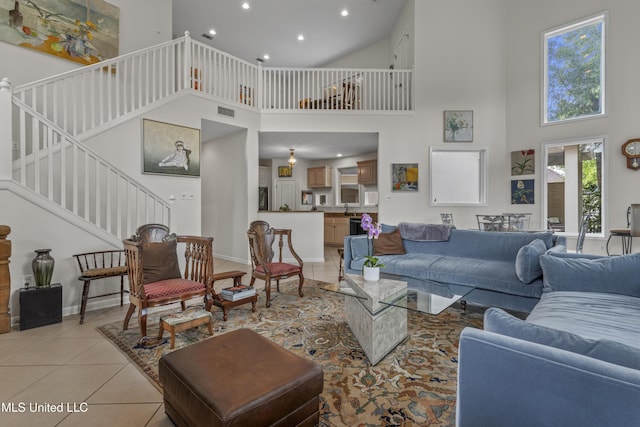 7395 Live Oak Way, Pass Christian, MS 39571 - living area featuring a high ceiling, light tile patterned floors, recessed lighting, stairs, and baseboards
