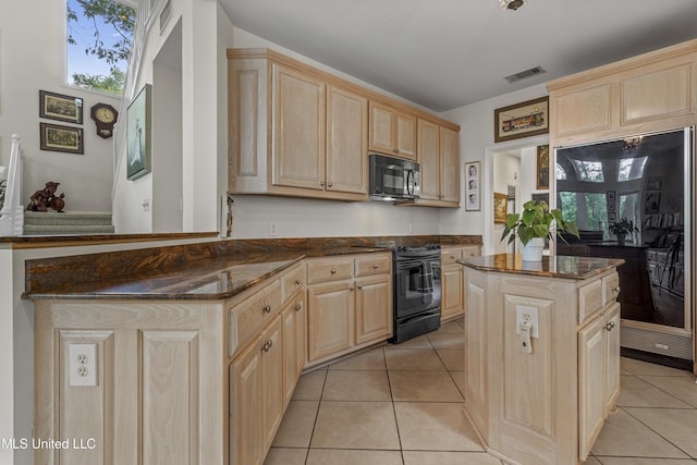 7395 Live Oak Way, Pass Christian, MS 39571 - kitchen featuring light brown cabinetry, black appliances, light tile patterned floors, and dark stone countertops