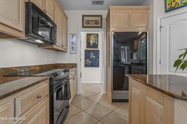 7395 Live Oak Way, Pass Christian, MS 39571 - kitchen featuring black appliances, light brown cabinets, dark stone countertops, and light tile patterned floors
