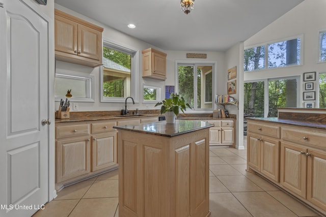 7395 Live Oak Way, Pass Christian, MS 39571 - kitchen with a sink, light brown cabinetry, light tile patterned floors, a center island, and dark stone counters