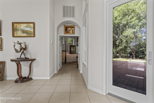 7395 Live Oak Way, Pass Christian, MS 39571 - hall with light tile patterned floors, baseboards, and arched walkways