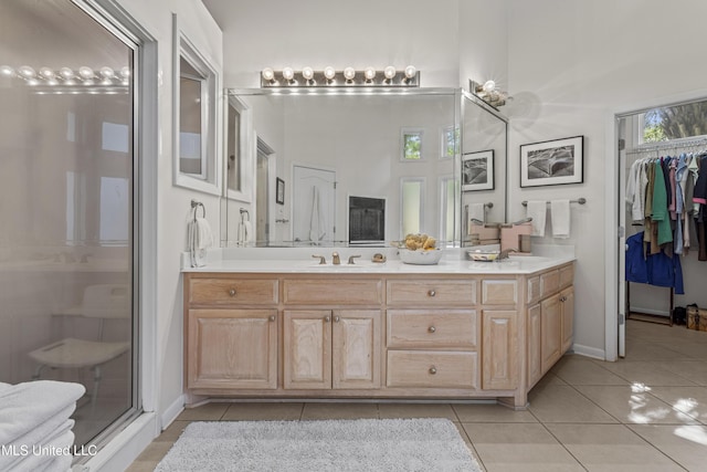 7395 Live Oak Way, Pass Christian, MS 39571 - full bathroom featuring tile patterned flooring, double vanity, a shower stall, a high ceiling, and a spacious closet