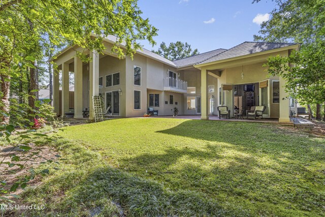 7395 Live Oak Way, Pass Christian, MS 39571 - back of house with stucco siding, a lawn, and a patio area