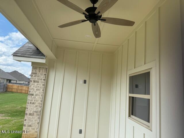 317 Willow Way Unit 158, Canton, MS 39046 - exterior space featuring fence, board and batten siding, a ceiling fan, and a yard