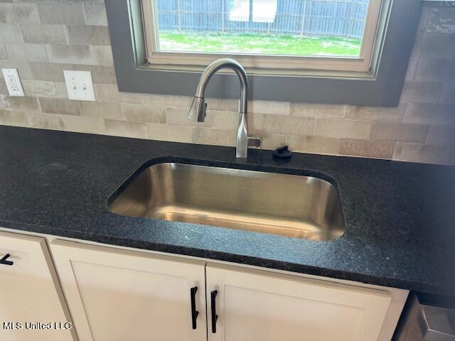 317 Willow Way Unit 158, Canton, MS 39046 - room details featuring backsplash, a sink, and white cabinetry