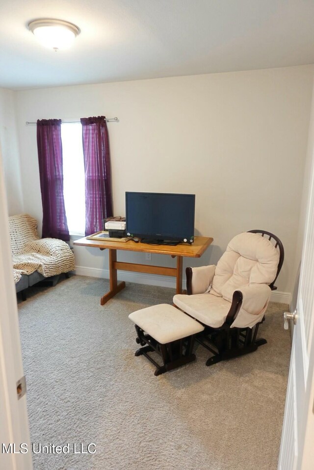 sitting room featuring carpet flooring and baseboards