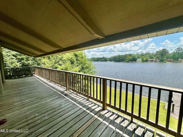 577 W Lakeshore Dr, Carriere, MS 39426 - wooden deck with a water view and a lawn