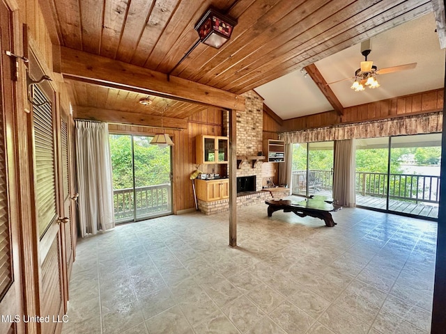 577 W Lakeshore Dr, Carriere, MS 39426 - living area with wooden walls, healthy amount of natural light, a brick fireplace, a ceiling fan, and wood ceiling