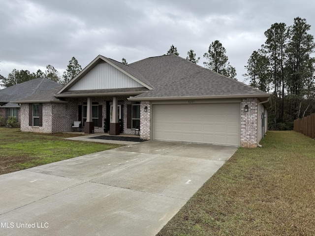 view of front of property featuring covered porch, a garage, and a front lawn