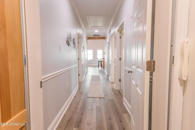 5004 Oak St, Bay Saint Louis, MS 39520 - hallway featuring attic access, ornamental molding, and light wood finished floors
