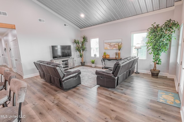 5004 Oak St, Bay Saint Louis, MS 39520 - living room featuring ornamental molding, plenty of natural light, light wood-style flooring, and high vaulted ceiling