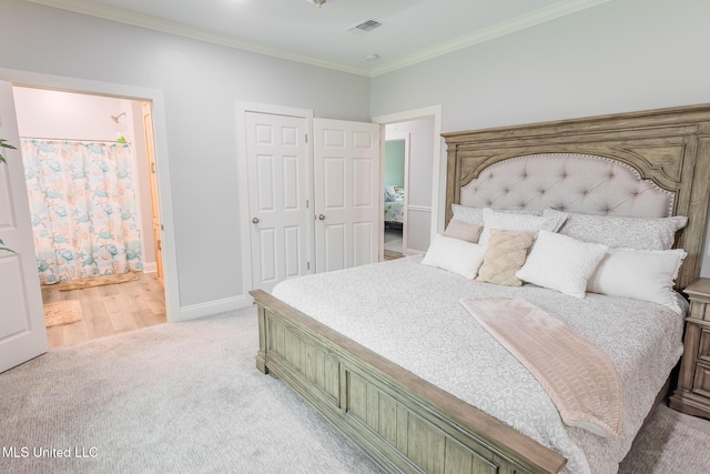 5004 Oak St, Bay Saint Louis, MS 39520 - bedroom featuring light carpet, crown molding, and ensuite bath