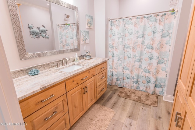 5004 Oak St, Bay Saint Louis, MS 39520 - bathroom featuring wood finished floors, vanity, and curtained shower