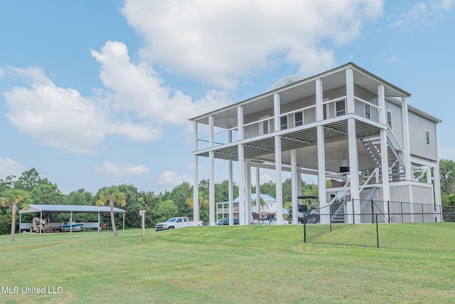 5004 Oak St, Bay Saint Louis, MS 39520 - back of property with stairs, a carport, and board and batten siding
