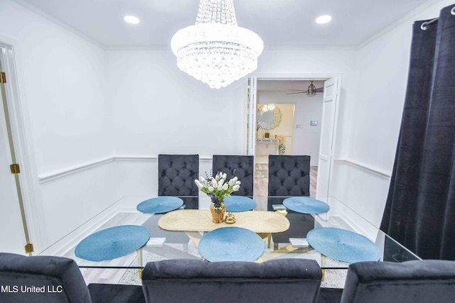 dining room with ornamental molding, wood-type flooring, and ceiling fan with notable chandelier