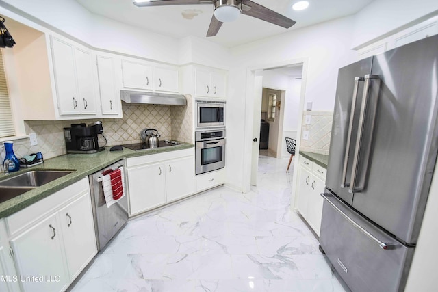 kitchen featuring appliances with stainless steel finishes, white cabinets, and backsplash