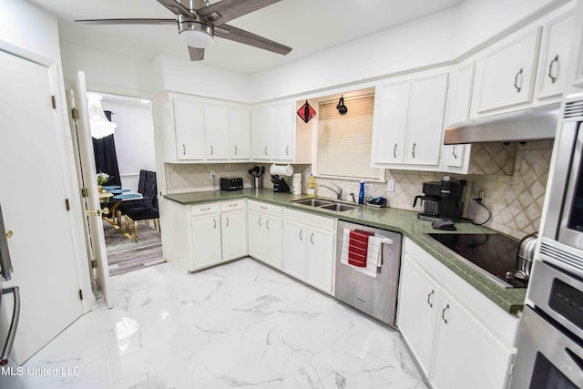 kitchen featuring decorative backsplash, stainless steel appliances, sink, white cabinets, and ceiling fan