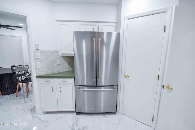 kitchen featuring white cabinetry, tasteful backsplash, high quality fridge, and ceiling fan