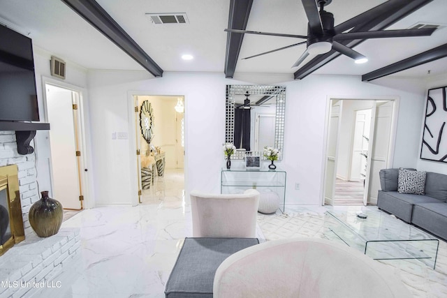 living room with beamed ceiling, a fireplace, and ceiling fan