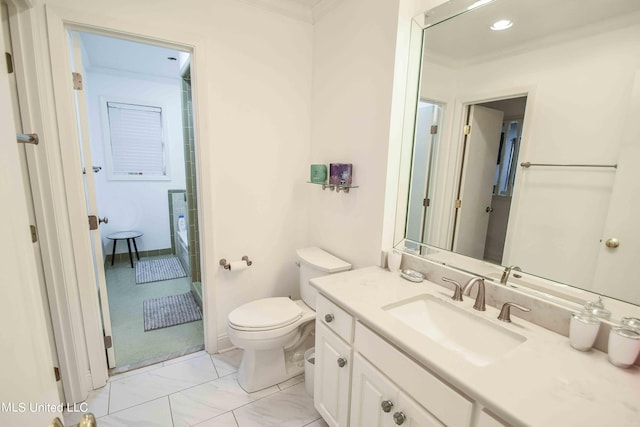 bathroom with vanity, crown molding, and toilet