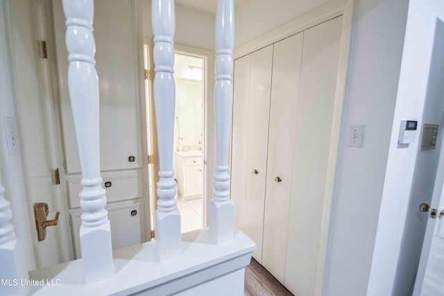 interior space with vanity and hardwood / wood-style flooring