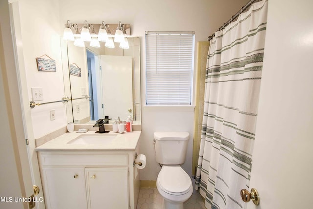 bathroom with vanity, toilet, and walk in shower