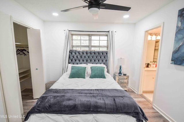 bedroom featuring a closet, ensuite bath, hardwood / wood-style flooring, and ceiling fan