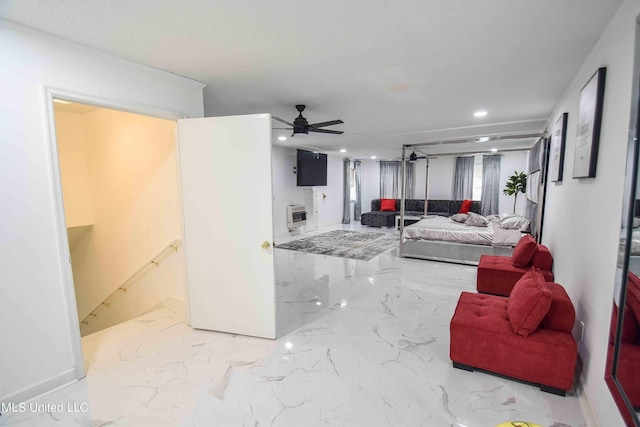 living room featuring ceiling fan and heating unit