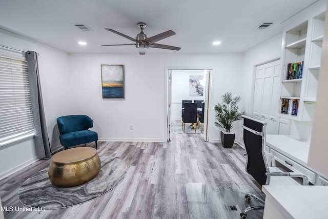 office with light hardwood / wood-style floors and ceiling fan