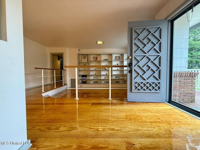 foyer featuring baseboards and wood finished floors