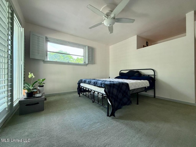 carpeted bedroom with baseboards and ceiling fan