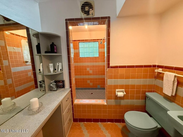 bathroom with tile walls, tile patterned flooring, a stall shower, and toilet