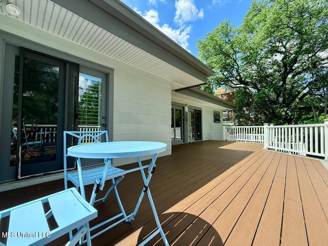 wooden terrace with outdoor dining area
