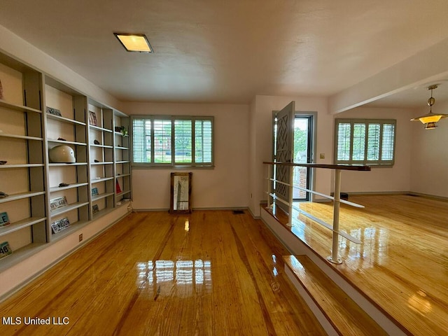 empty room featuring baseboards and wood finished floors