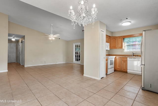 kitchen featuring light tile patterned flooring, vaulted ceiling, pendant lighting, ceiling fan, and white appliances