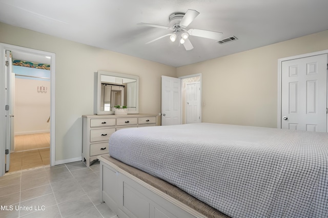 tiled bedroom featuring ceiling fan