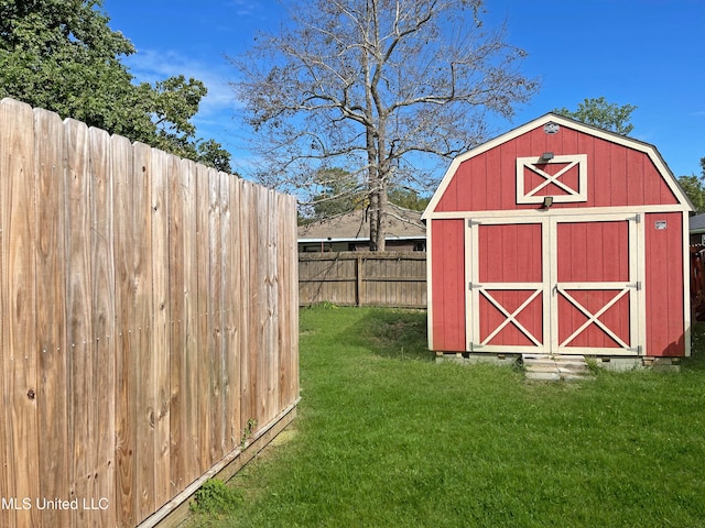 view of outdoor structure featuring a lawn