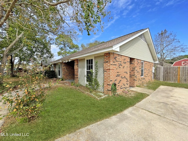 view of property exterior featuring a yard and a patio area