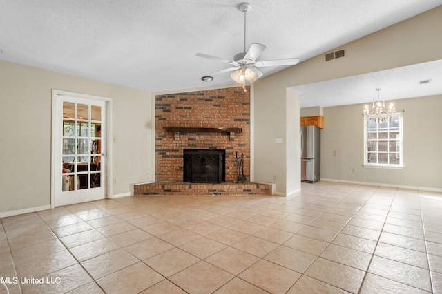 unfurnished living room featuring light tile patterned floors, a wealth of natural light, and a textured ceiling